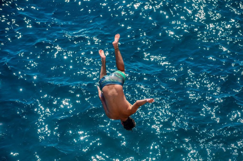 A diver leaps into the Adriatic