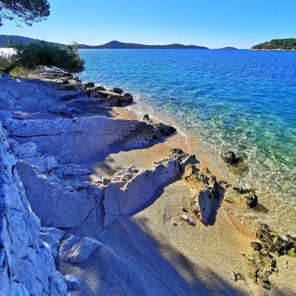 From the shadows, a Rogoznica beach view