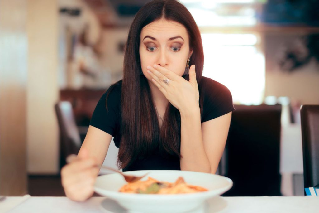 Image of woman experiencing wrong food pairing