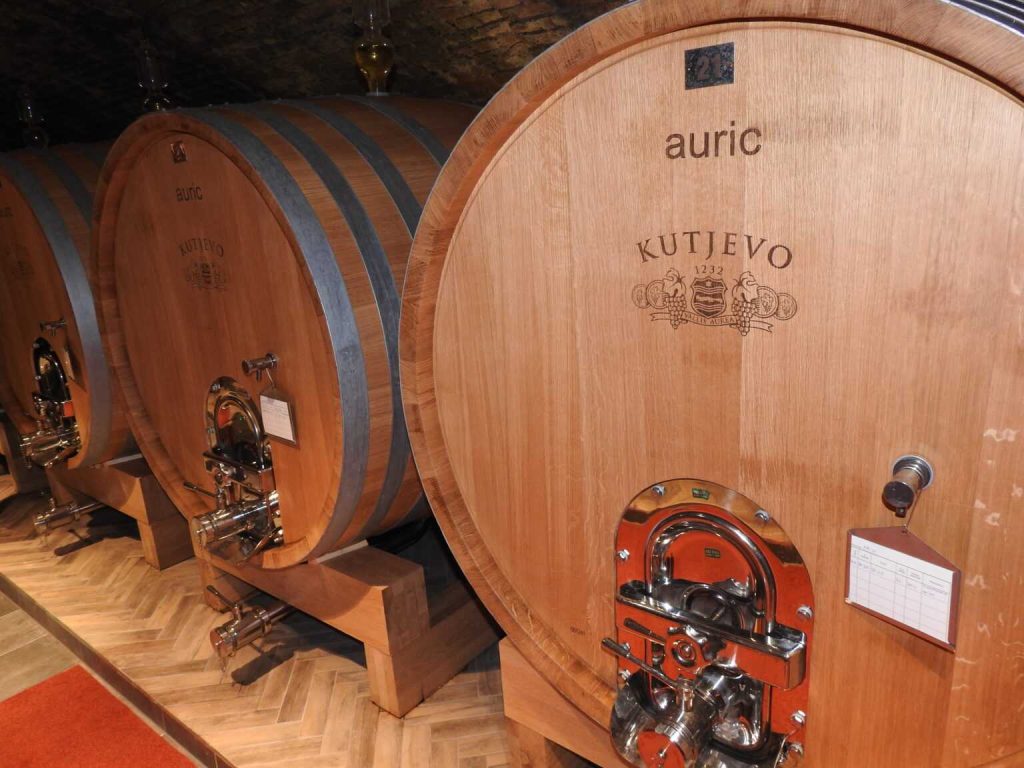 Image of oak barrels in the wine cellar of Kutjevo Winery